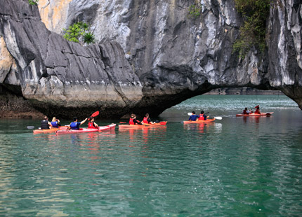 The excursion team guides guests through the Dark & Bright Cave via kayak.