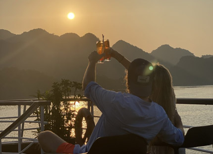 A sunset party featuring local snacks and fruits is held