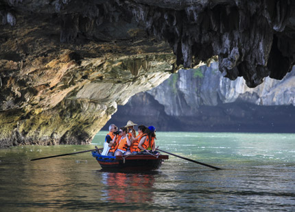 Explore the Light Cave area by traditional bamboo sampan